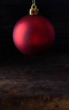 Ahşap tahta agaisnt koyu arka plan üzerinde kırmızı Noel topları