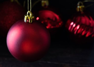 Ahşap tahta agaisnt koyu arka plan üzerinde kırmızı Noel topları