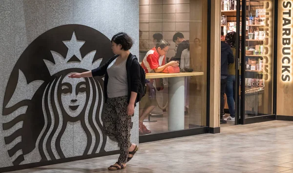 Tokyo, Japonya - 23 Haziran 2018. İnsanların önünde ofstarbucks kahve yürüyüş çıkış Shibuya içinde ev.