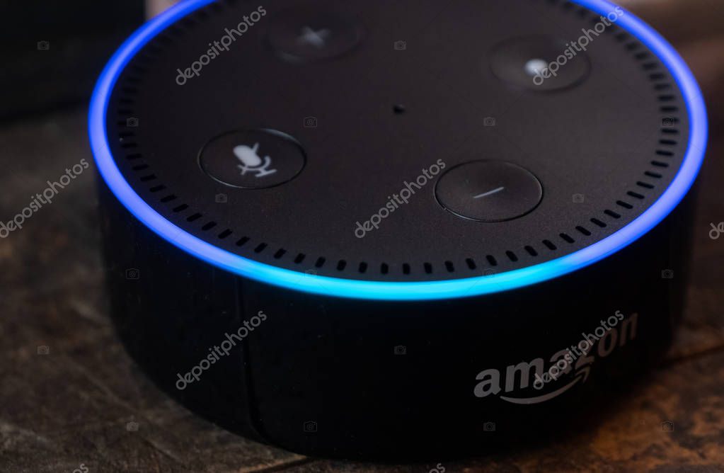 TOKYO, JAPAN - JUNE 28TH, 2018. Amazon's Echo Dot, Alexa virtual assistant on wooden board.
