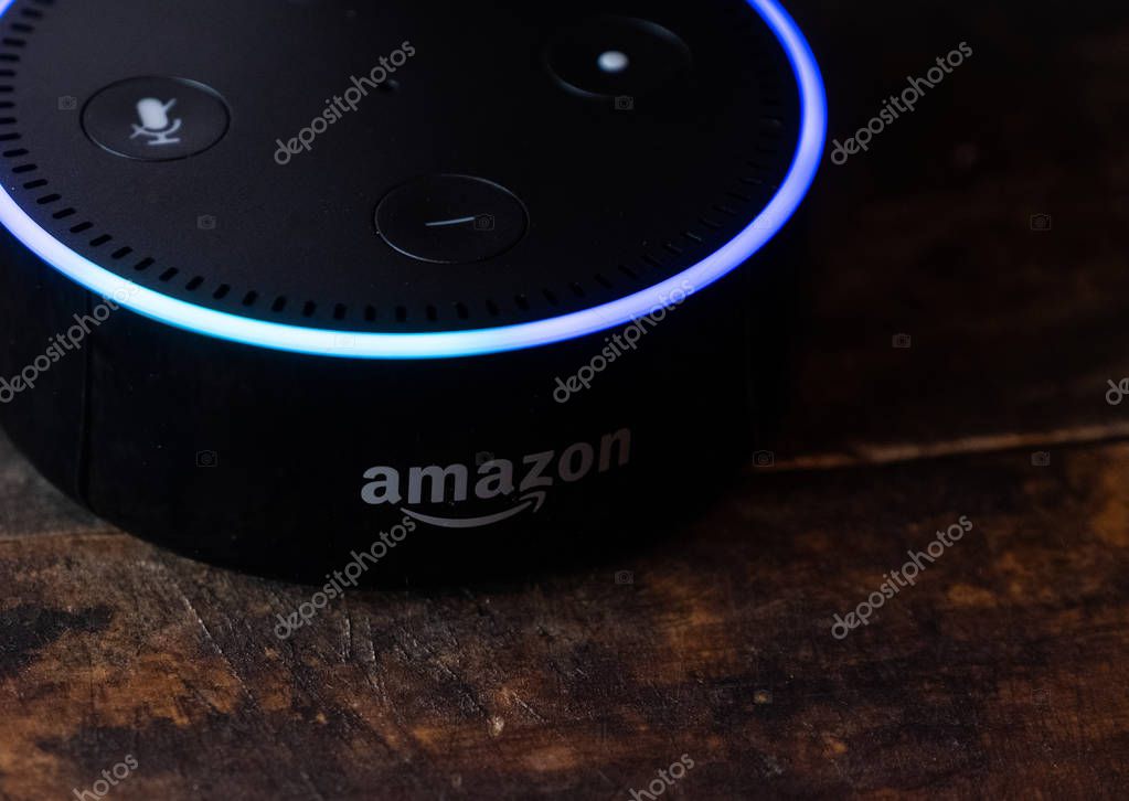TOKYO, JAPAN - JUNE 28TH, 2018. Amazon's Echo Dot, Alexa virtual assistant on wooden board.