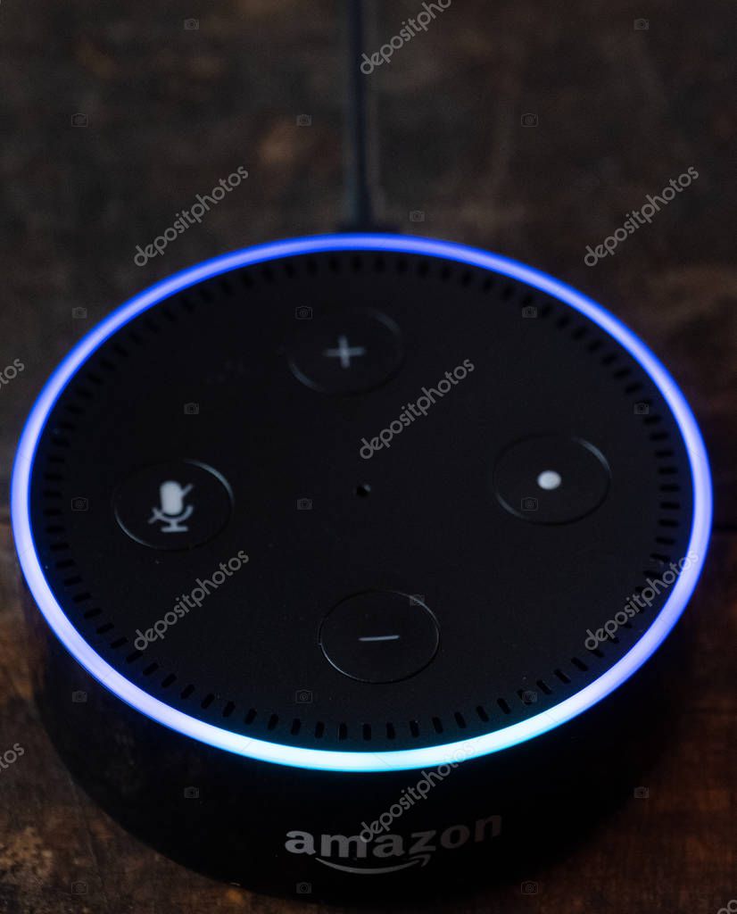TOKYO, JAPAN - JUNE 28TH, 2018. Amazon's Echo Dot, Alexa virtual assistant on wooden board.