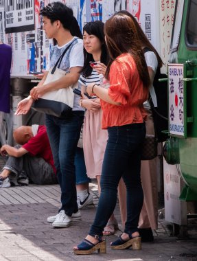 Tokyo, Japonya - 1 Temmuz 2018. Japon gençlik Hachiko meydanında, Shibuya takılmak