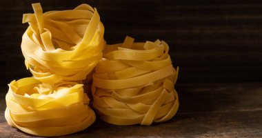 Ahşap tahta üzerinde kurutulmuş tagliatelle makarna