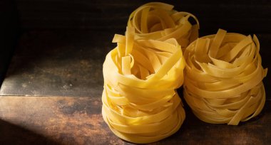 Ahşap tahta üzerinde kurutulmuş tagliatelle makarna