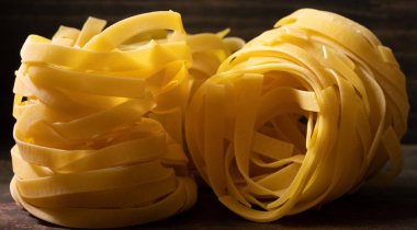 Ahşap tahta üzerinde kurutulmuş tagliatelle makarna