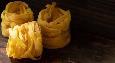 Ahşap tahta üzerinde kurutulmuş tagliatelle makarna