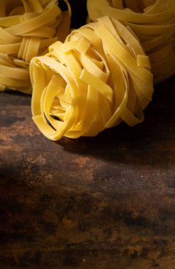 Ahşap tahta üzerinde kurutulmuş tagliatelle makarna