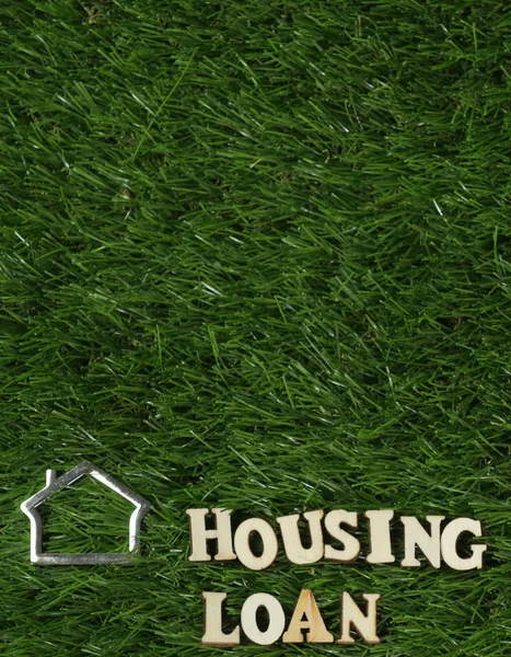 HOUSING LOAN text  on green grass.