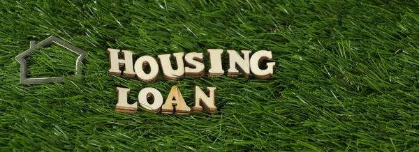 HOUSING LOAN text  on green grass.