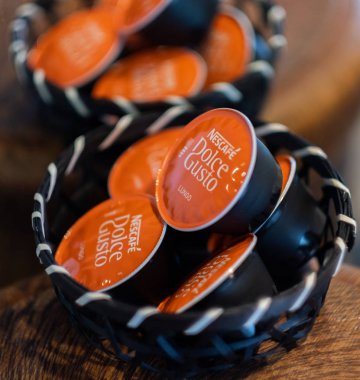 Tokyo, Japonya - 5 Ağustos 2018. Ahşap kapsayıcısındaki nescafe Dolce Gusto Lungo kahve kapsül. Seçici odak.