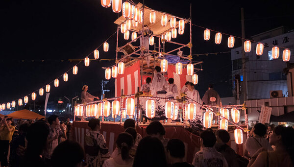TOKYO, JAPAN - AUGUST 12TH, 2018. Crowd of people dancing at the Bon Odori celebration in Shimokitazawa neighborhood at night.