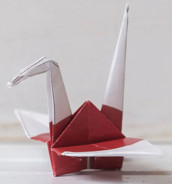 Japanese flag origami paper crane on tabletop