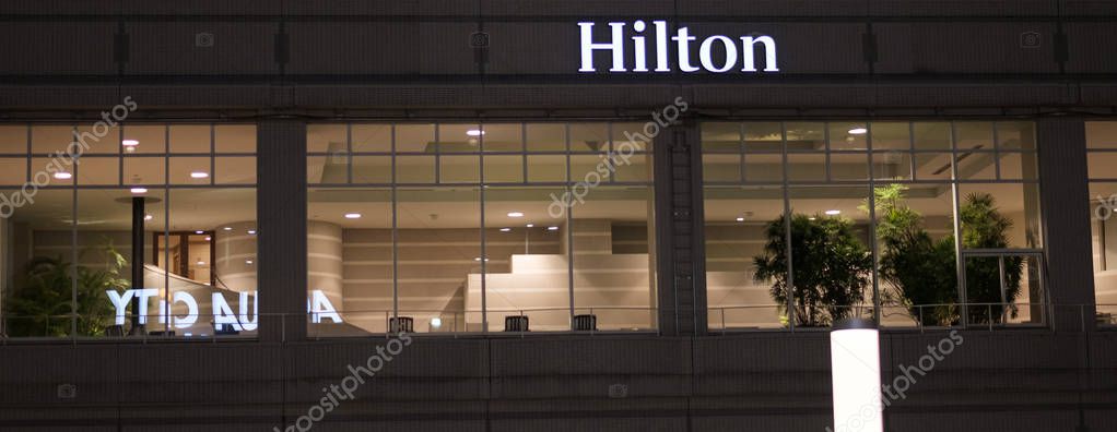 TOKYO, JAPAN - AUGUST 15TH, 2018. Illuminated Hilton Hotel Sign at night in Odaiba.