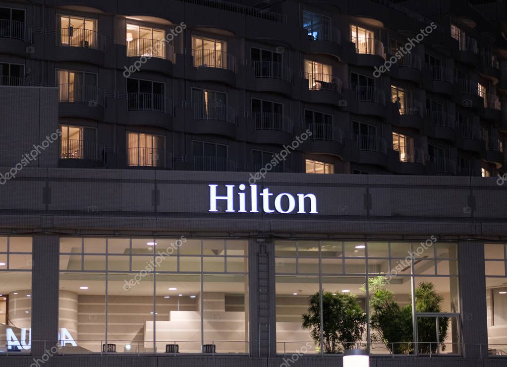 TOKYO, JAPAN - AUGUST 15TH, 2018. Illuminated Hilton Hotel Sign at night in Odaiba.