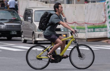 Tokyo, Japonya - 19 Ağustos 2018. Adam sokakta Shibuya bir bisiklet sürme