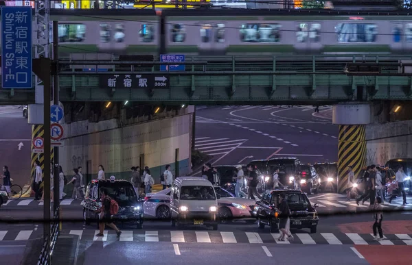 2018 東京都 新宿歌舞伎町地区における道路橋の上を通過する通勤電車 — ストック写真