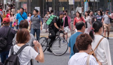 Tokyo, Japonya - 19 Ağustos 2018. Uber yiyor binici Shibuya Caddesi Bisiklete binme.
