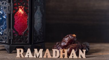 Ahşap arka plan üzerinde Ramadhan metin ve fener ile Tarihler meyve