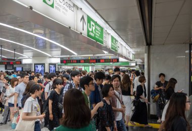 Tokyo, Japonya - 30 Haziran 2018. Japonya demiryolu Shinjuku İstasyonu platformları arasında yürüyüş commuters.