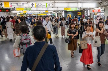 Tokyo, Japonya - 30 Haziran 2018. Japonya demiryolu Shinjuku İstasyonu platformları arasında yürüyüş commuters.
