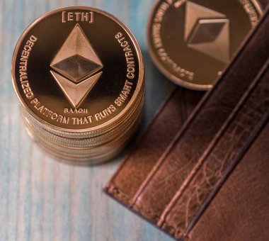 Ahşap masa üzerinde deri cüzdan ile Ethereum sikkeler