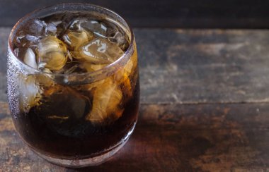 Bir bardak kola içkiler ahşap masa üstü buz ile