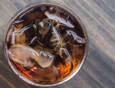 Bir bardak kola içkiler ahşap masa üstü buz ile
