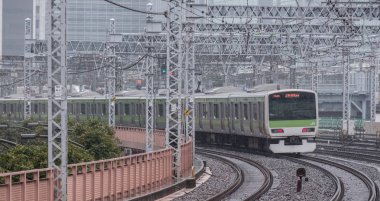 Tokyo, Japonya - 16 Eylül 2018. Işık sabah çiseleyen yağmur sırasında Japonya demiryolu Yamanote satır banliyö treni Yurakucho İstasyonu.