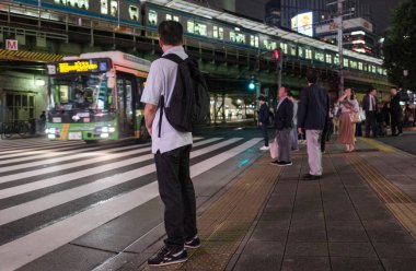 Tokyo, Japonya - 15 Eylül. Yaya geceleri karşıya Yurakucho tren istasyonu önünde bekleyen.