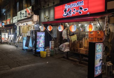 TOKYO, JAPAN - SEPTEMBER 15TH, 2018. Small eateries or locally known as izakaya at Yurakucho district back alley at night. clipart