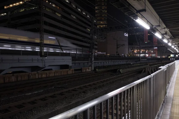 2018 東京都 夜の有楽町駅の線路を通過する日本高速弾丸列車のぼやけた映像 — ストック写真