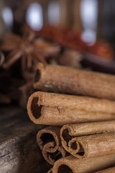 Cinnamon sticks on the dark wood table.