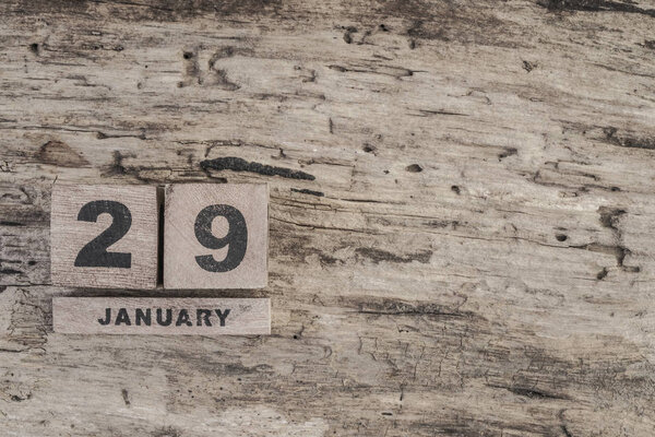 Cube calendar for january on wooden background with copy space