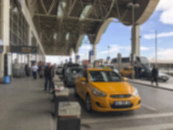 Blurred background with taxi and people at terminal