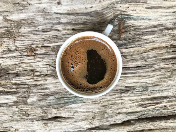 a cup of Turkish coffee on a wooden table