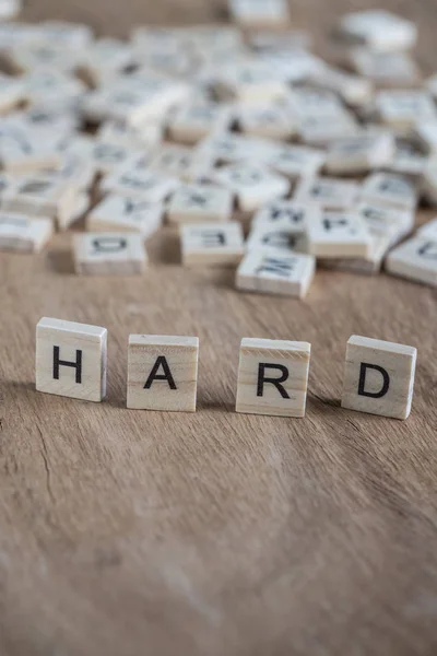 The word hard written with cube letters on wood — Stock Photo, Image