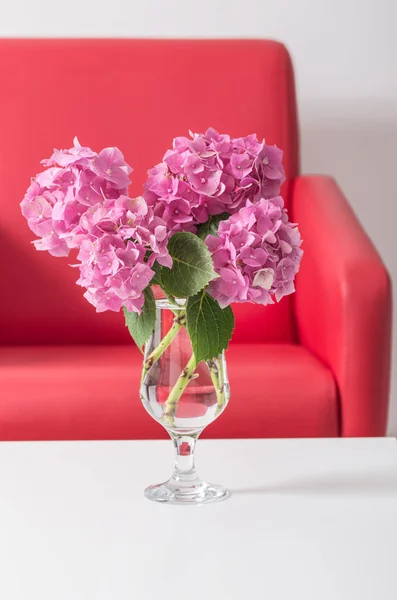 pink hydrangea flowers in vase on a table