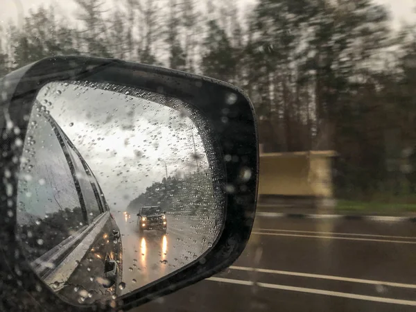 Rain drops and reflection of a car on mirror — Stock Photo, Image
