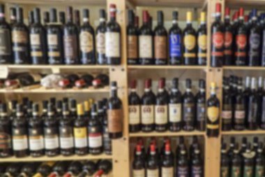 bir mağazada raflarda şarap şişeleri ile bulanık arka plan