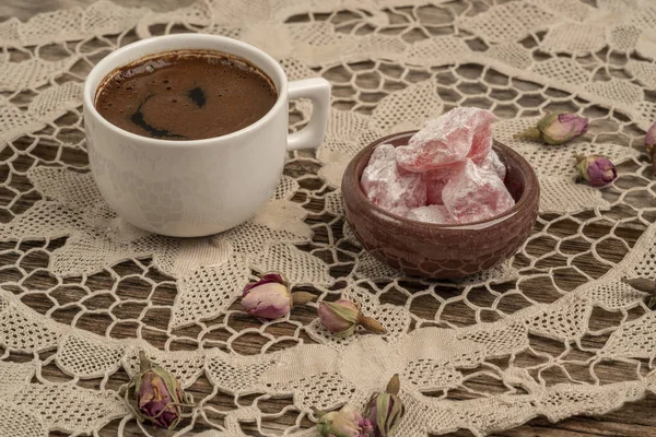 kurutulmuş gül fl ile dekore edilmiş masada kahve ve türk lokumu