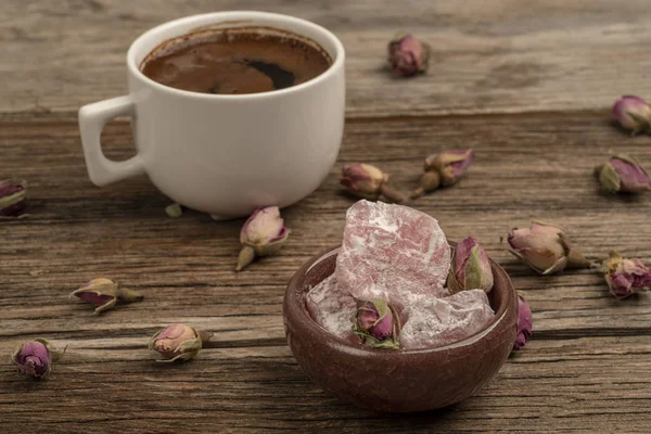 Coffee and turkish delight on a wooden table decorated with drie — Stock Photo, Image