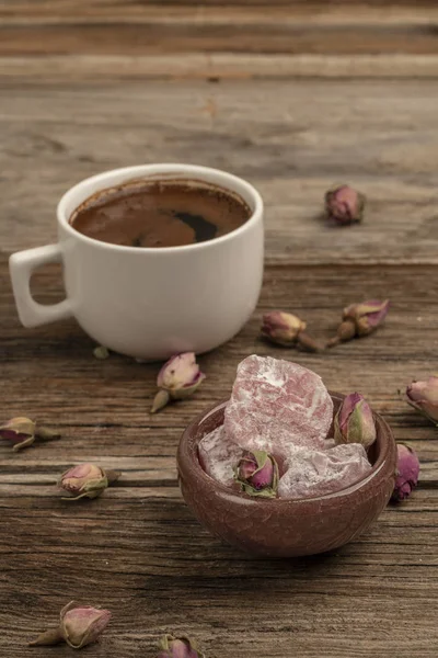 Coffee and turkish delight on a wooden table decorated with drie — Stock Photo, Image