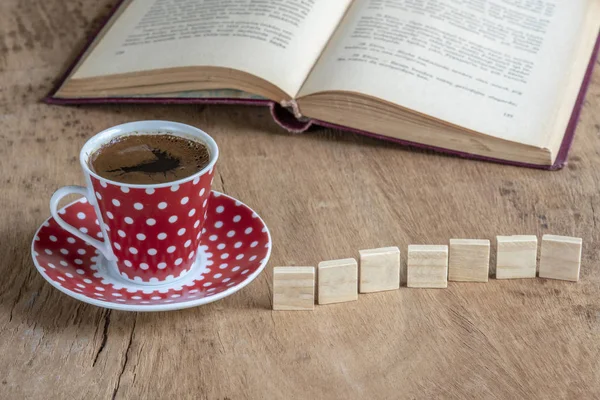 Book and coffee cup on table with copy space