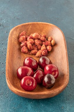 Fotokopi alanı olan bir masada taze kiraz meyvesi ve arta kalan tohumlar.