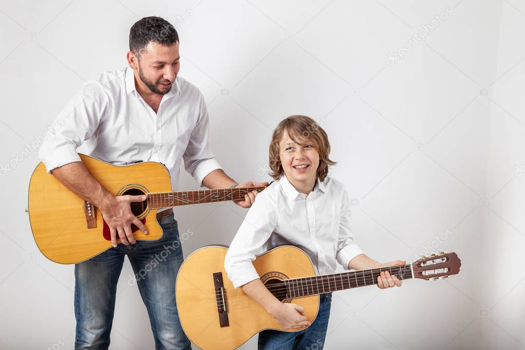 Father and son playing guitars