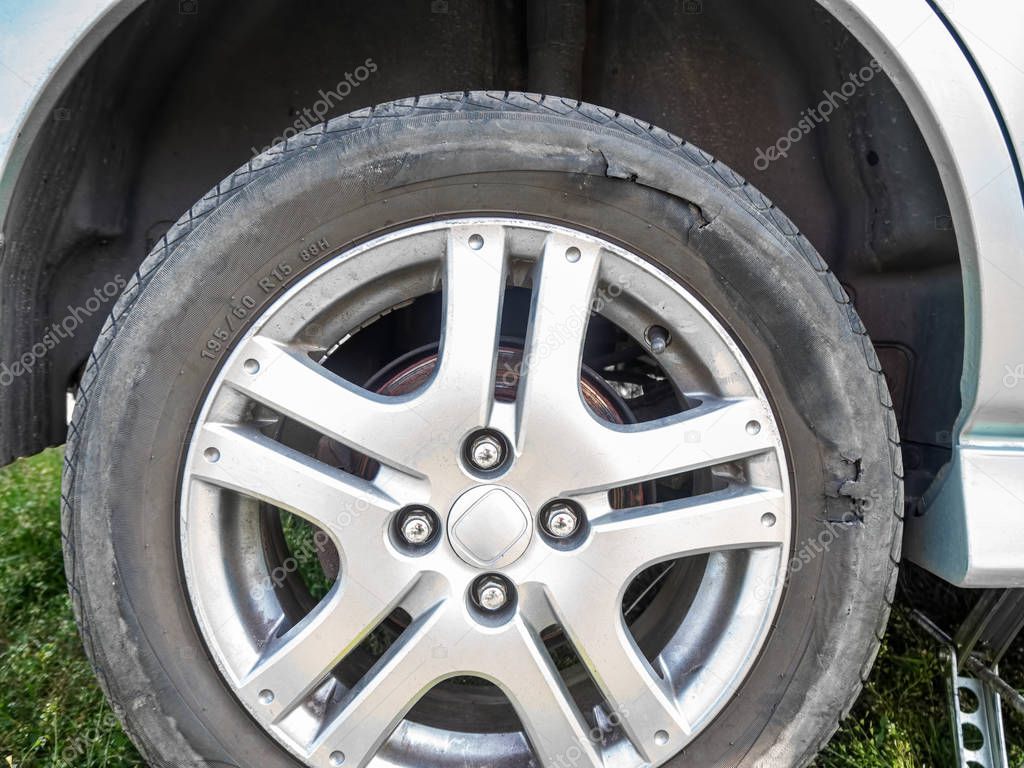 Damaged car tire with a hole