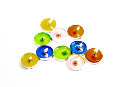 Küçük yanan mumlar beyaz arka plan üzerinde renkli