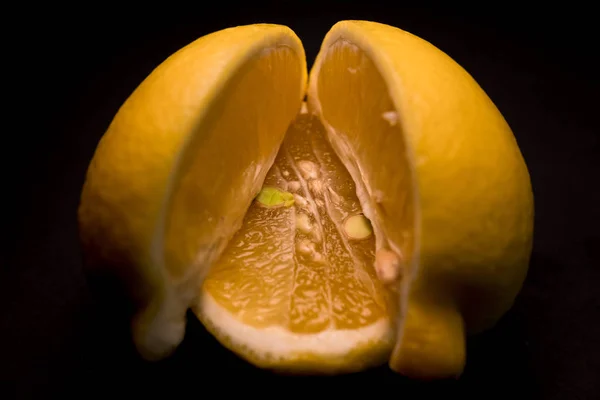 juicy yellow lemon on a black background, screen saver and wallpaper