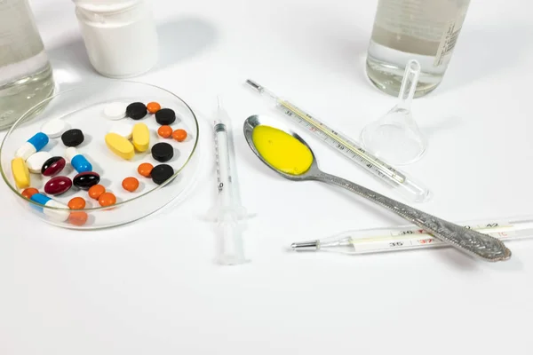 Variety medicines and syringe, isolated on white background